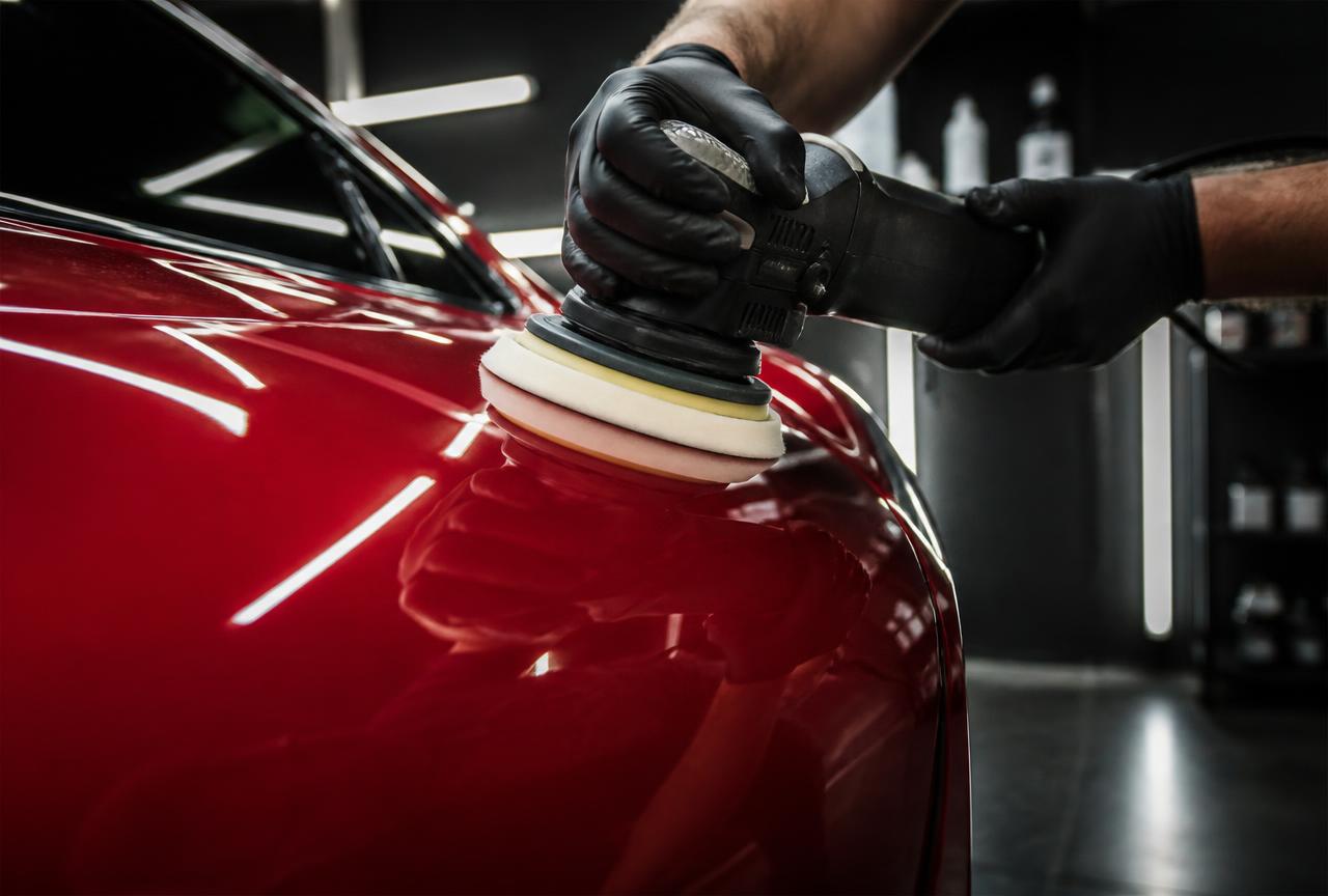 Machine polishing red car paint to a mirror gloss
